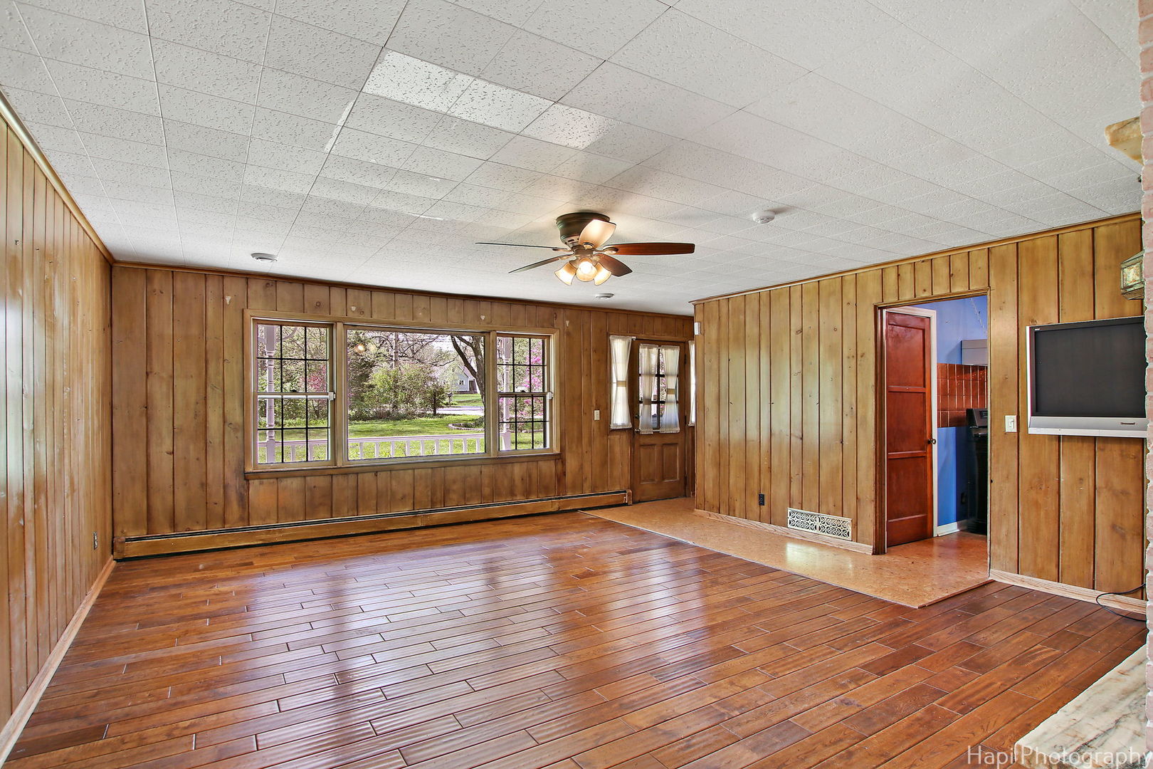 27797 North Forest Garden Road Wauconda, IL 60084 - Photo 5 of 35 an empty room with wooden floor and windows