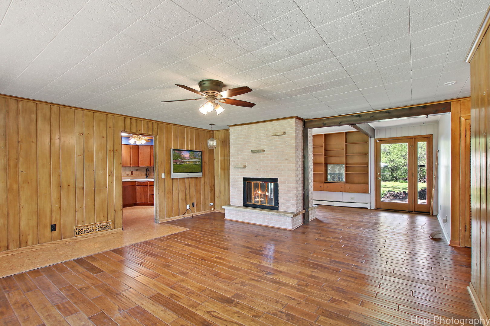 27797 North Forest Garden Road Wauconda, IL 60084 - Photo 7 of 35 an empty room with wooden floor fireplace and windows