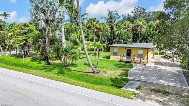 a view of a house with a yard and a garden