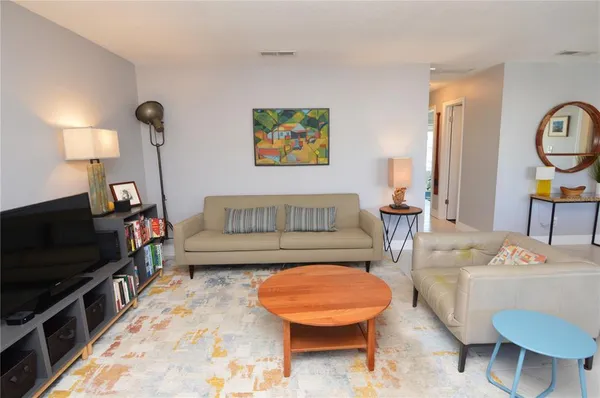 a bedroom with two beds and wooden floor