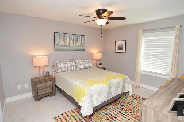 a bedroom with a bed and a window