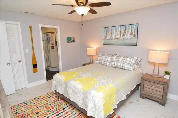 a bedroom with a bed and a chandelier