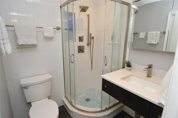 a view of a brick house with a small yard and plants