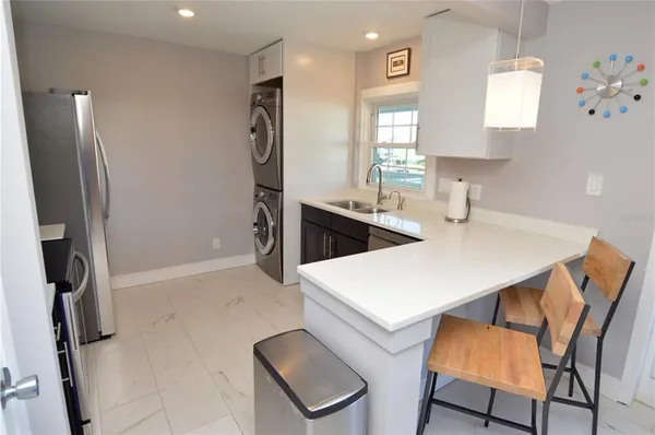 a living room with furniture a fireplace and large windows