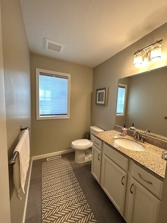35 Pine Hill Road Springfield, MA 01118 - Photo 10 of 31 a spacious bathroom with a granite countertop sink a toilet and a mirror