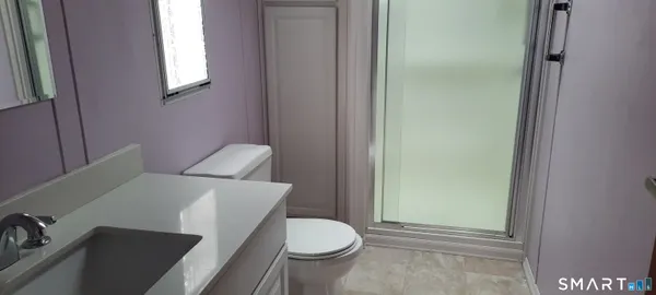 a white toilet sitting next to a bathroom sink