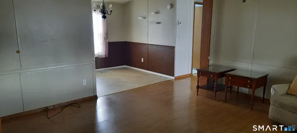an empty room with wooden floor and furniture