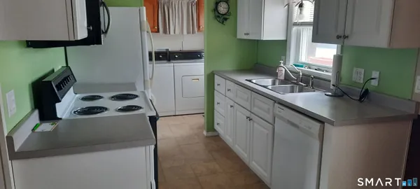 a kitchen with a sink and a refrigerator