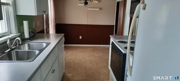 a kitchen with a sink and a refrigerator
