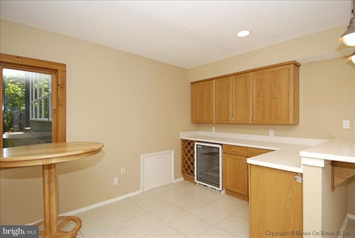 630 Utterback Store Road Great Falls, VA 22066 - Photo 5 of 30 a kitchen with stainless steel appliances granite countertop a sink and a stove top oven