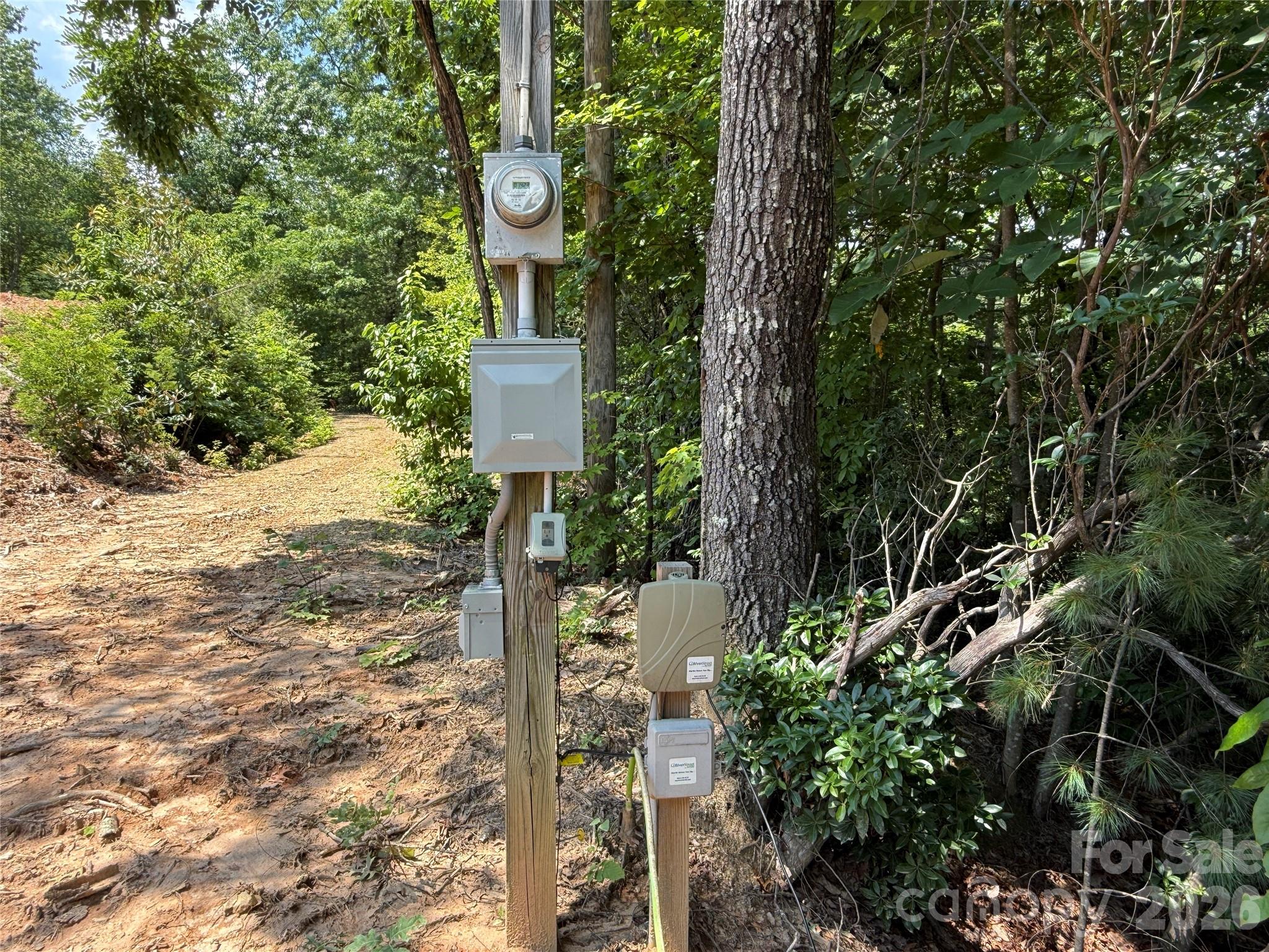 337 Lucas Path Drive, Unit 69 Purlear, NC 28665 - Photo 22 of 44 a sign that is on a tree in front of a house