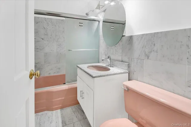 a bathroom with a sink a toilet and bathtub