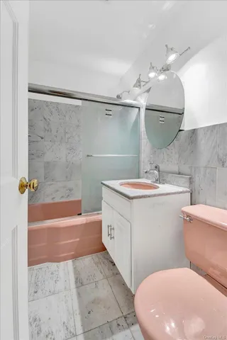 a bathroom with a sink a toilet and bathtub
