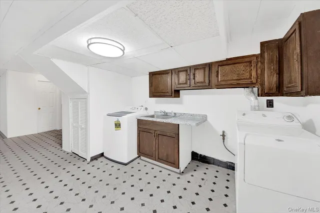 a kitchen with a sink a stove top oven and cabinets