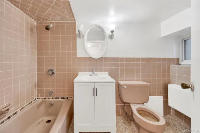 a bathroom with a toilet a sink and bathtub