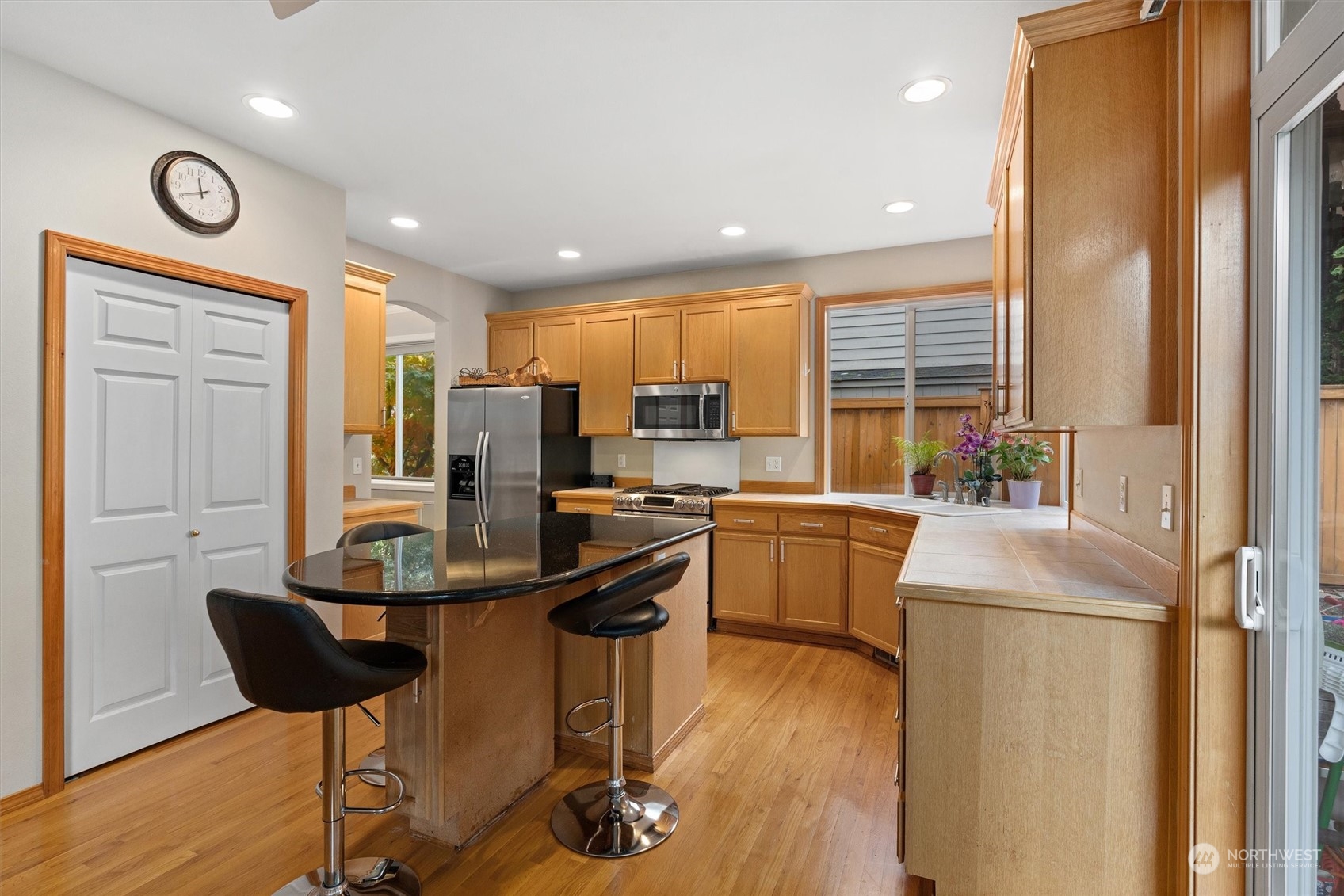 1124 184th Place Southeast Bothell, WA 98012 - Photo 12 of 35 a kitchen with stainless steel appliances granite countertop a refrigerator and a stove top oven