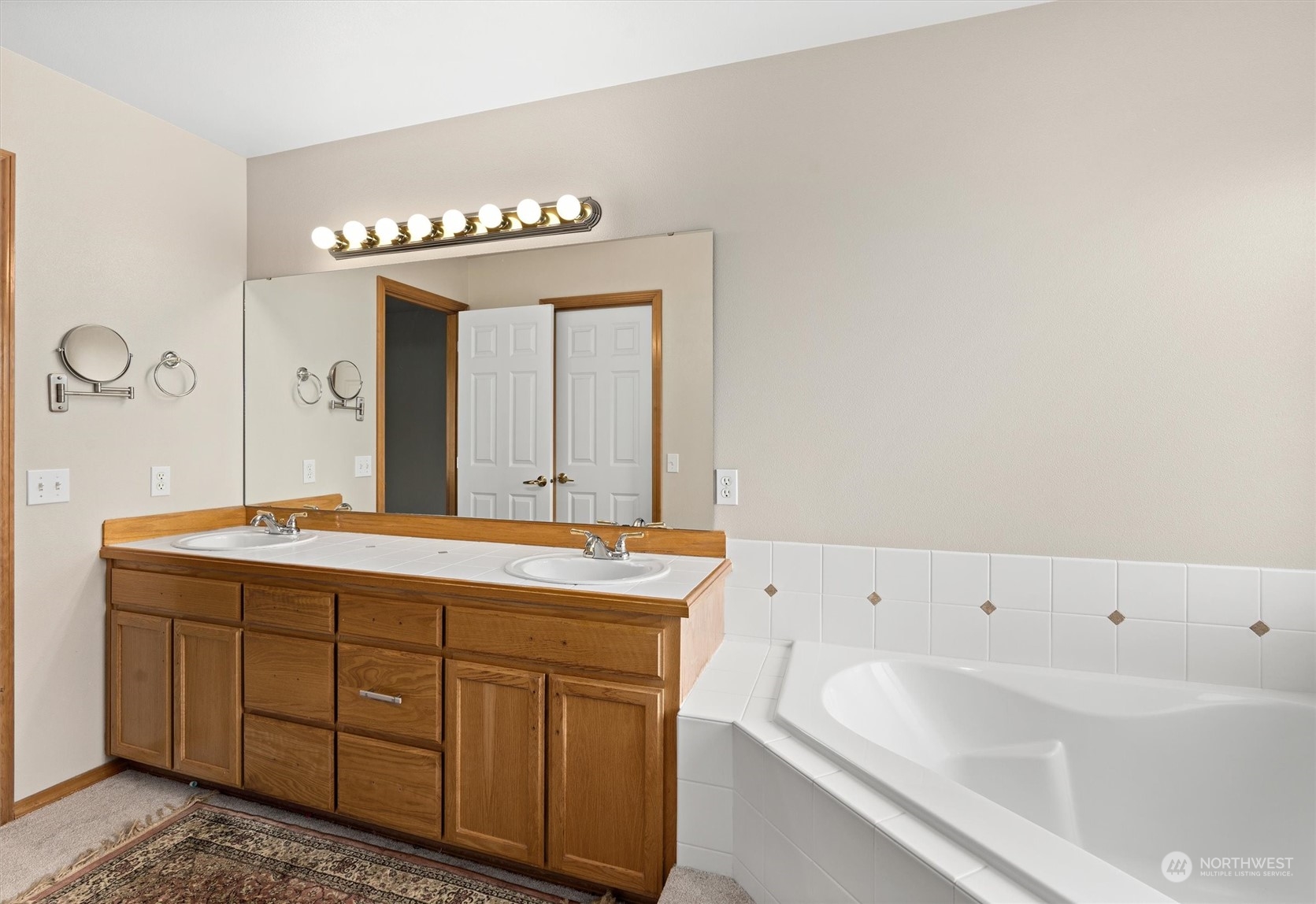 1124 184th Place Southeast Bothell, WA 98012 - Photo 22 of 35 a spacious bathroom with a tub sink and mirror