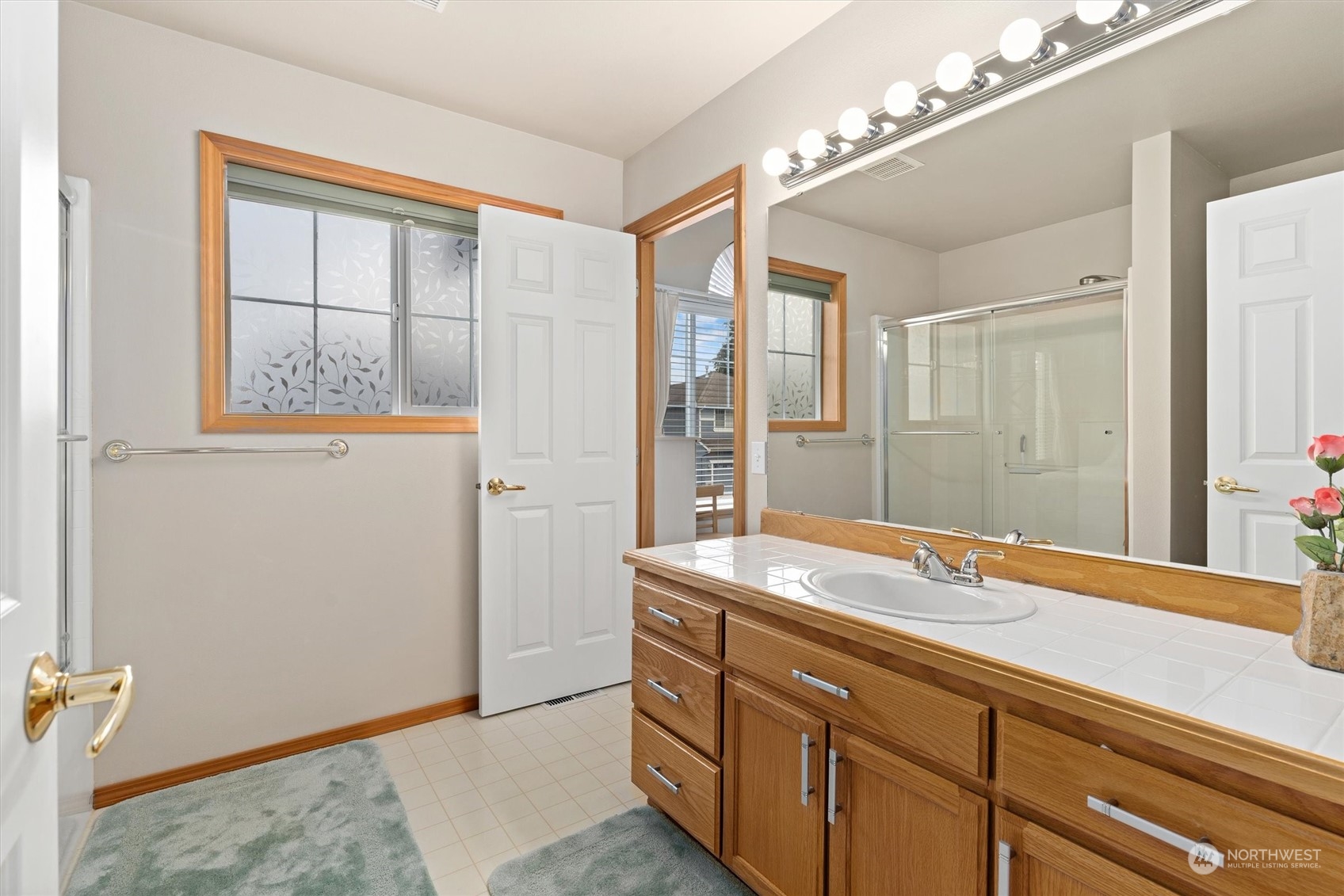1124 184th Place Southeast Bothell, WA 98012 - Photo 27 of 35 a bathroom with a granite countertop sink mirror and a shower