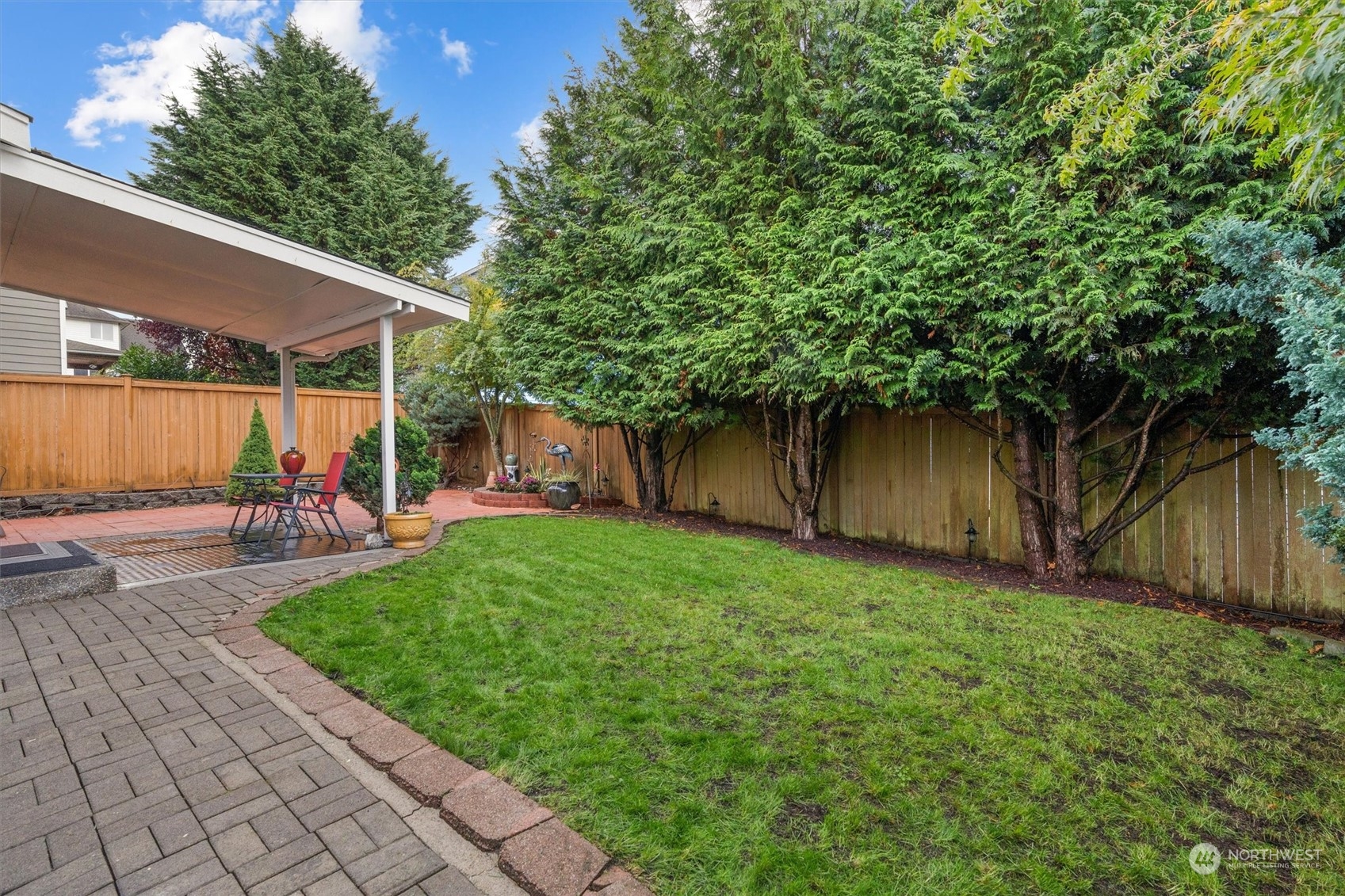 1124 184th Place Southeast Bothell, WA 98012 - Photo 35 of 35 a view of a backyard with table and chairs and a large tree