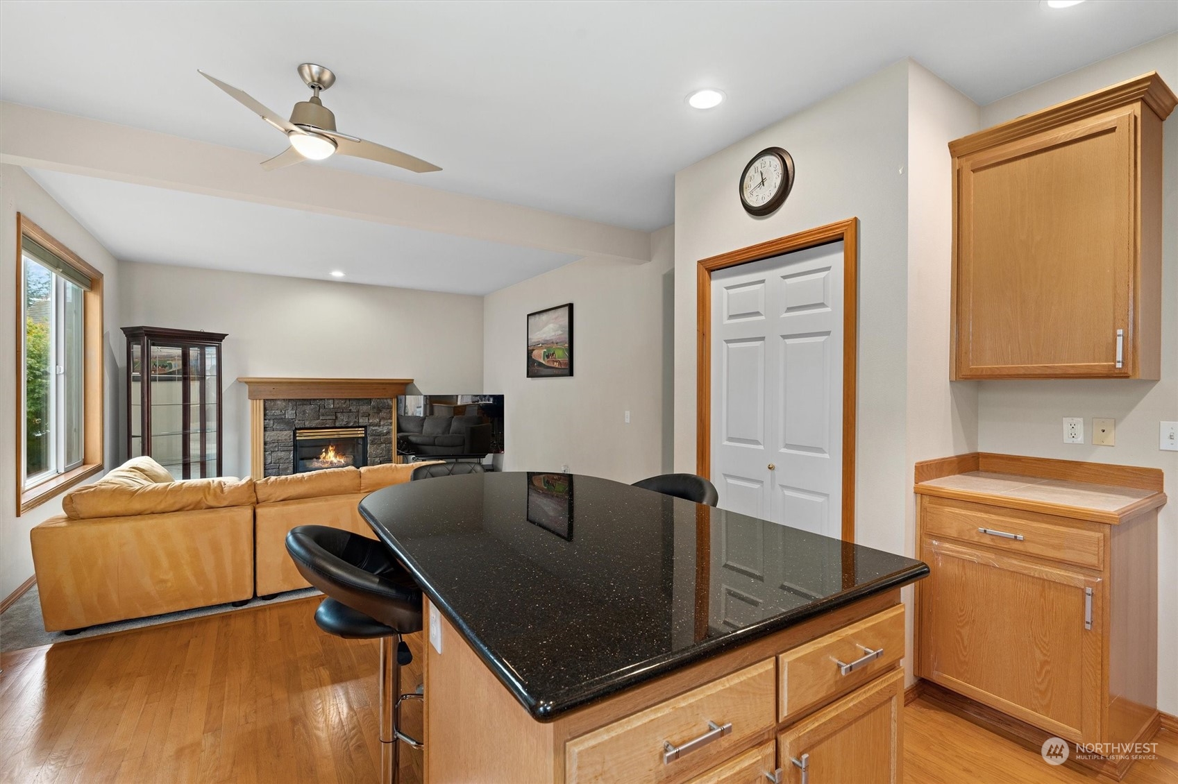 1124 184th Place Southeast Bothell, WA 98012 - Photo 10 of 35 a kitchen with granite countertop a stove a sink a dining table and chairs