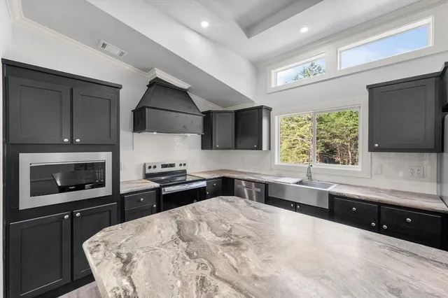 a kitchen with stainless steel appliances a stove sink and microwave