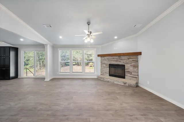 a view of an empty room with a fireplace and a window