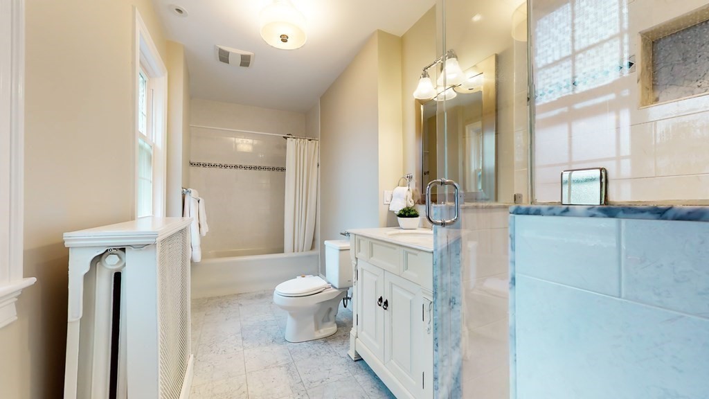 380 Jamaicaway Boston, MA 02130 - Photo 17 of 30 a spacious bathroom with a toilet sink and mirror