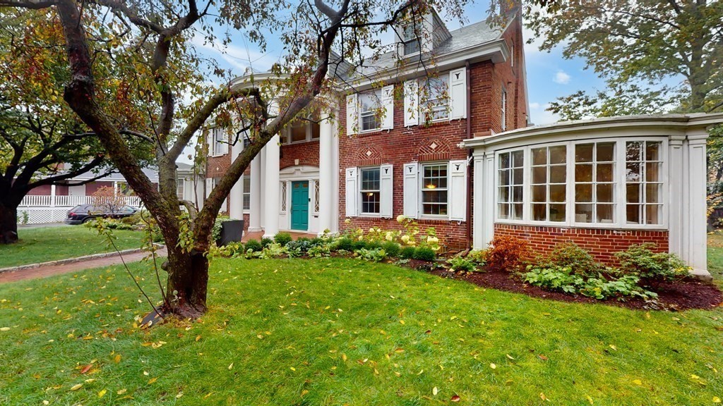 380 Jamaicaway Boston, MA 02130 - Photo 24 of 30 a large tree in front of a brick house with a large tree