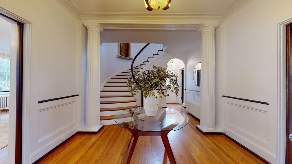 380 Jamaicaway Boston, MA 02130 - Photo 4 of 30 a view of a hallway with wooden floor and staircase