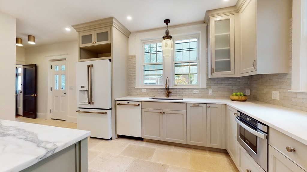 380 Jamaicaway Boston, MA 02130 - Photo 6 of 30 a kitchen with stainless steel appliances granite countertop a sink and a refrigerator