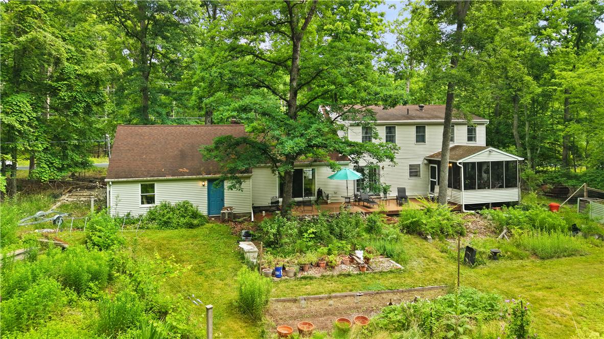 209 Remington Road East Stroudsburg, PA 18301 - Photo 35 of 41 A spacious home nestled amidst lush greenery, featuring a screened porch and expansive outdoor areas.