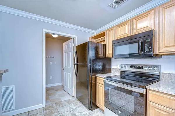a kitchen with stainless steel appliances granite countertop a stove a refrigerator and a microwave