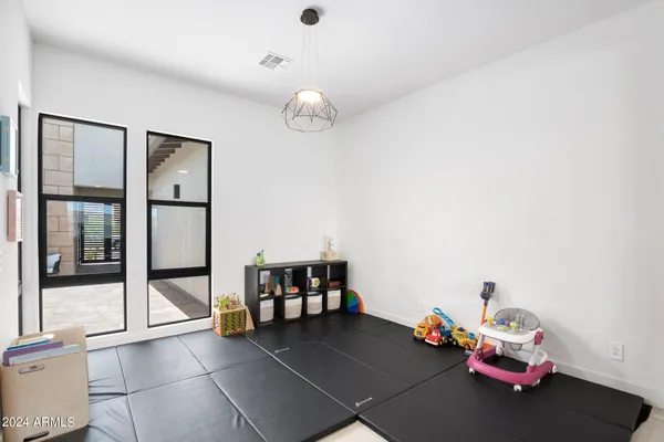 a bedroom with furniture ceiling fan and a flat screen tv