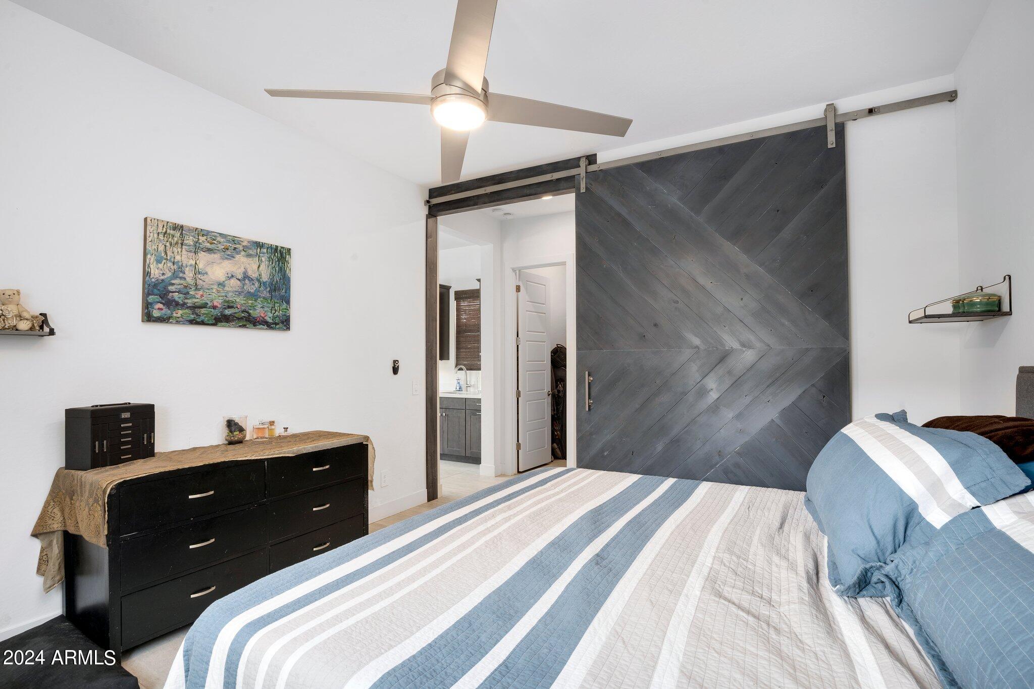 812 East Summerside Road Phoenix, AZ 85042 - Photo 28 of 64 a bedroom with a bed and a television