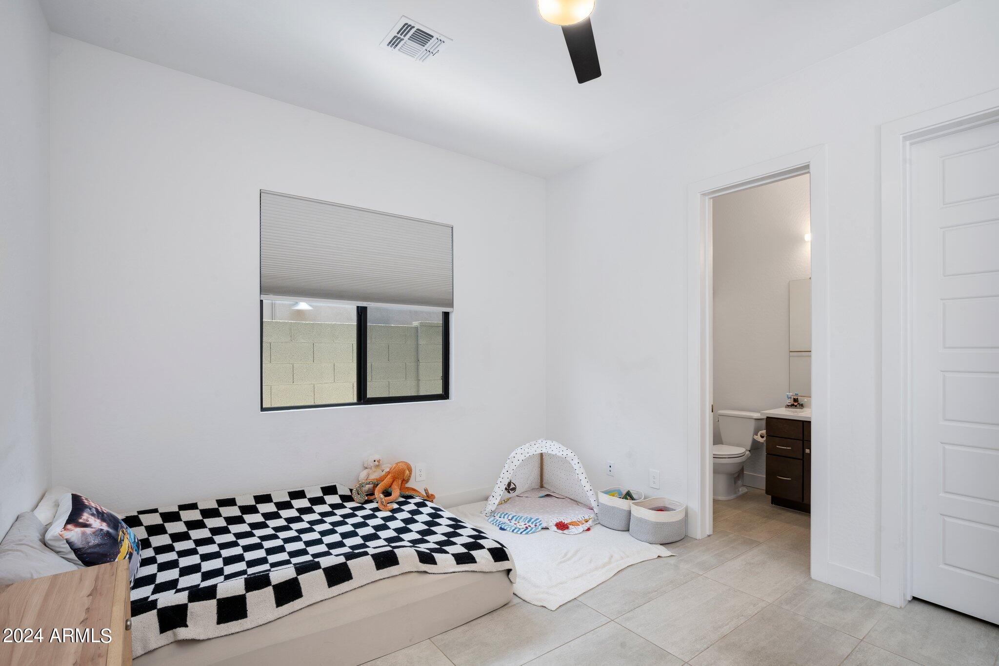 812 East Summerside Road Phoenix, AZ 85042 - Photo 37 of 64 a bedroom with bed and window