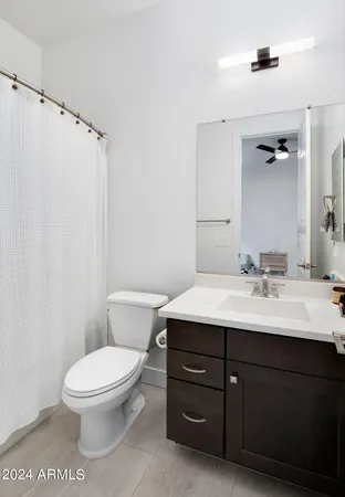 a view of a patio with couches and table and chairs and potted plants