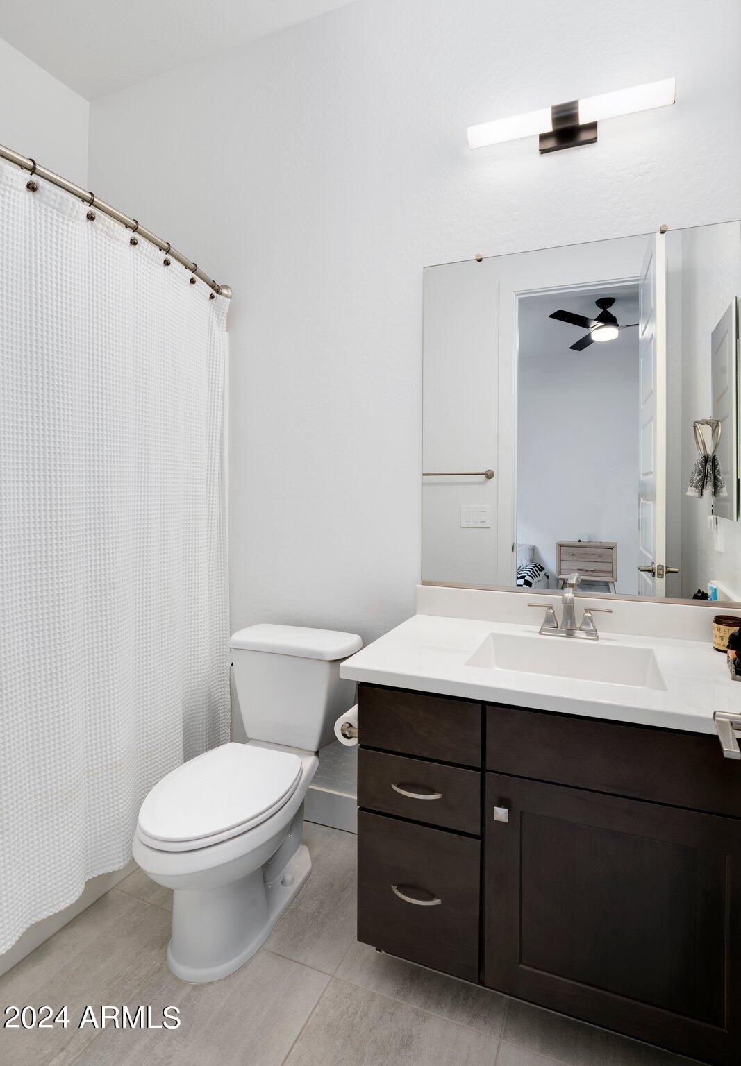 812 East Summerside Road Phoenix, AZ 85042 - Photo 38 of 64 a bathroom with a sink a toilet a mirror and shower
