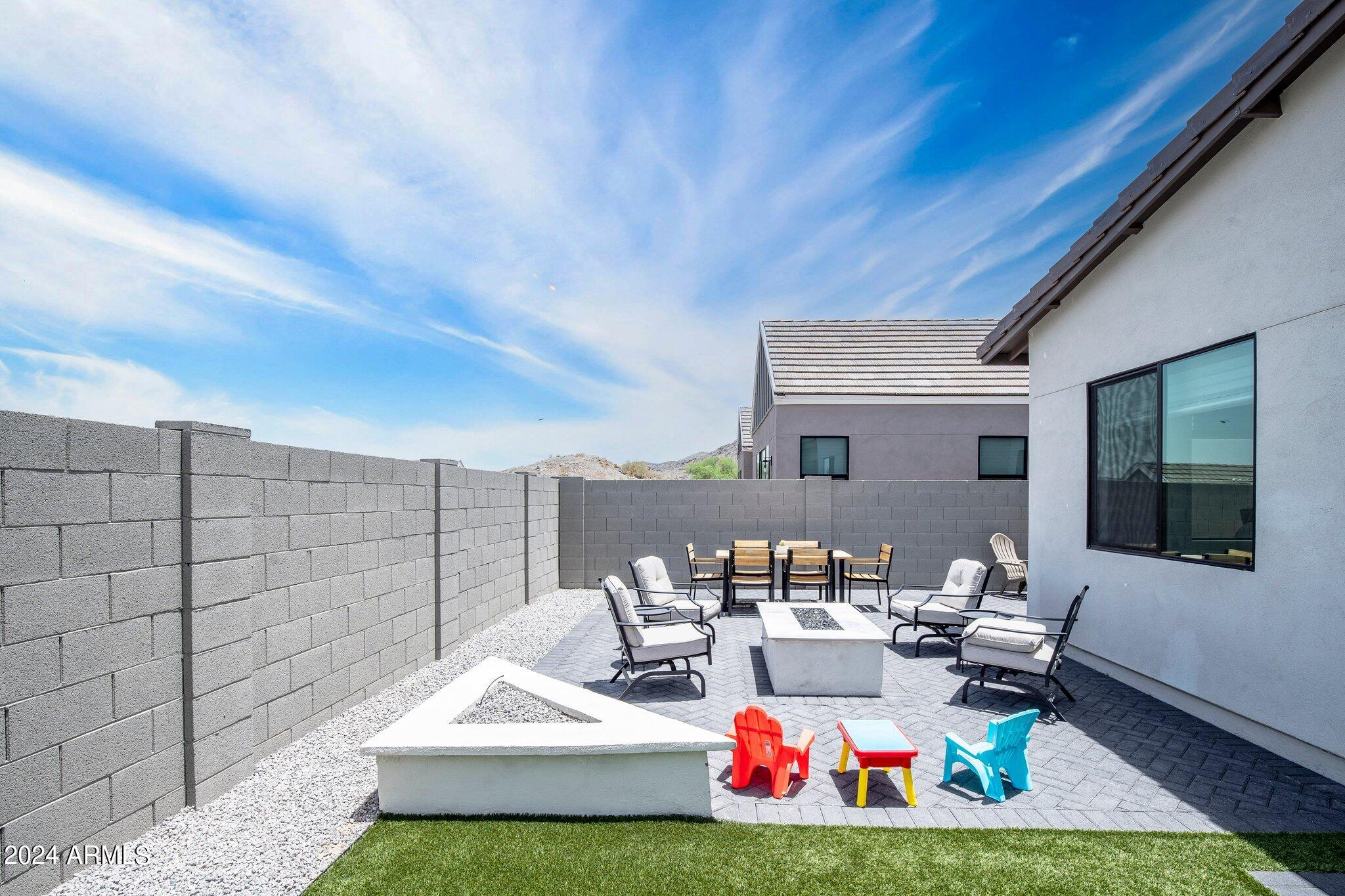 812 East Summerside Road Phoenix, AZ 85042 - Photo 43 of 64 a view of a patio with couches and table and chairs and potted plants
