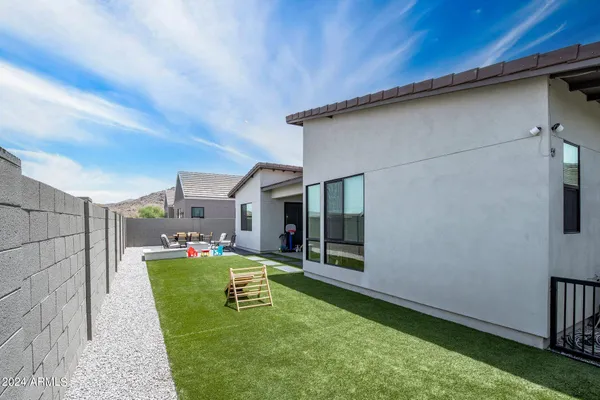 a living room with patio furniture and a floor to ceiling window
