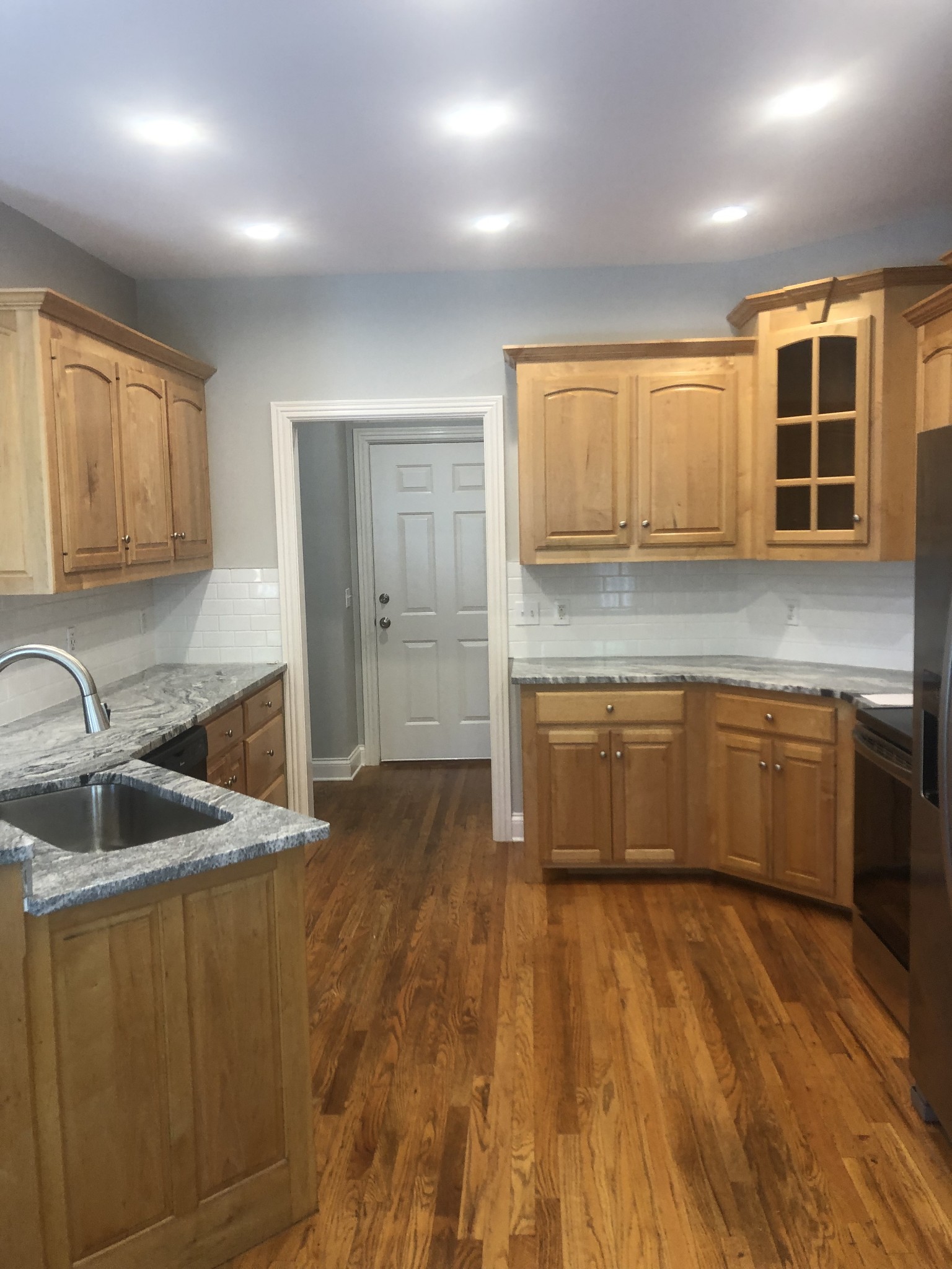 242 Ridgewater Way Mount Juliet, TN 37122 - Photo 20 of 24 a kitchen with kitchen island granite countertop a sink cabinets and wooden floor