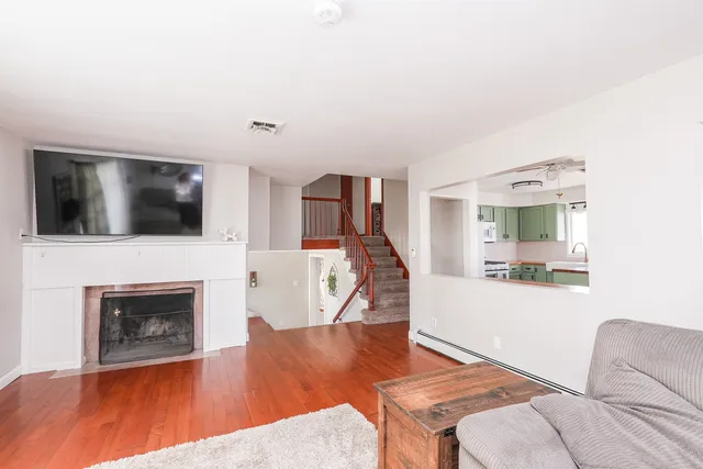 a living room with furniture fireplace and flat screen tv