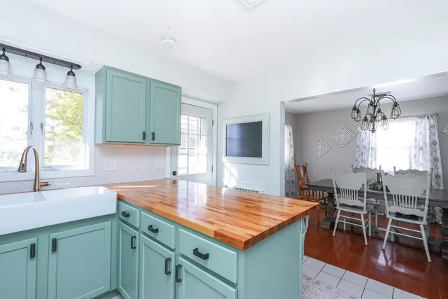 a bedroom with bed and a chandelier