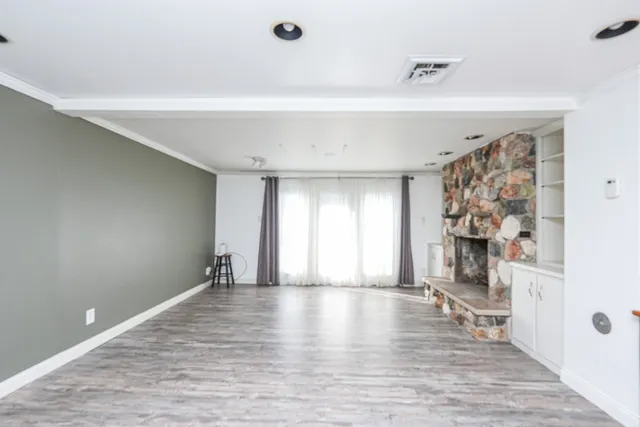 an empty room with a ceiling fan and a window
