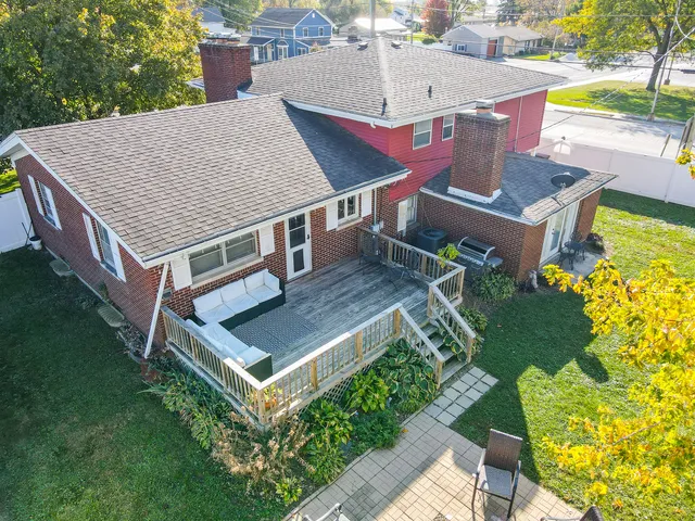 an aerial view of a house with a garden and lake view