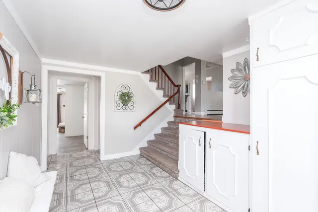 a view of entryway and hall with wooden floor