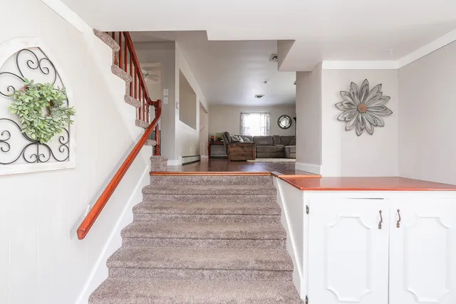a view of entryway and hall with a front door