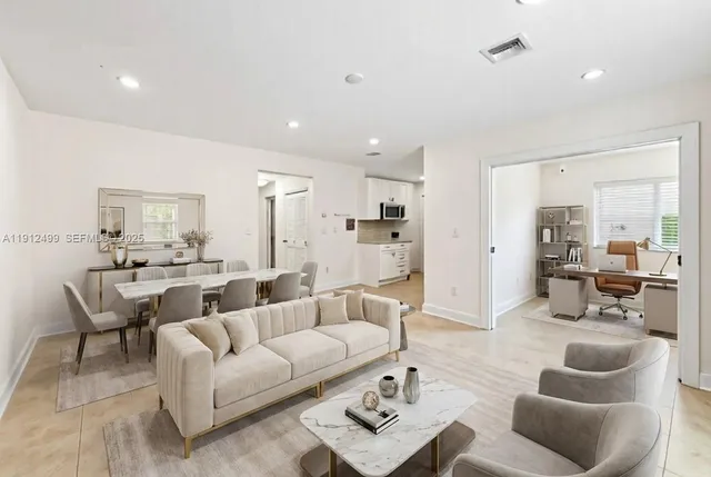 a living room with furniture and a large window