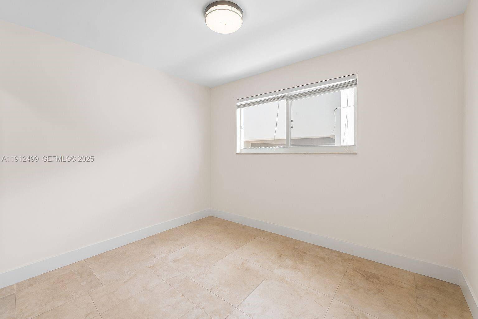 1601 Bay Road, Unit 4 Miami Beach, FL 33139 - Photo 13 of 17 an empty room with a window