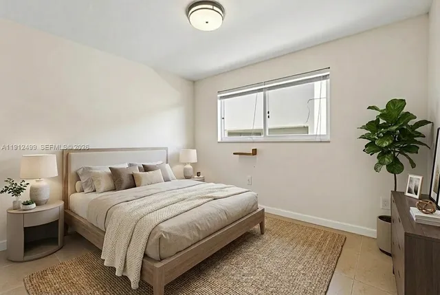 a bedroom with a bed and a potted plant