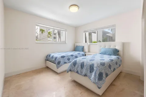 a bedroom with a bed and painting on the wall